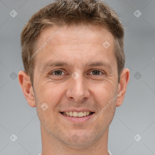 Joyful white adult male with short  brown hair and brown eyes