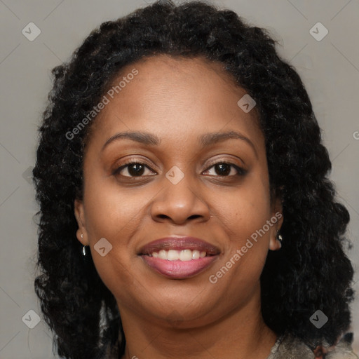 Joyful black young-adult female with long  brown hair and brown eyes