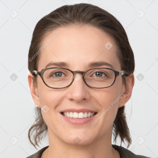 Joyful white young-adult female with medium  brown hair and grey eyes