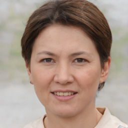 Joyful white adult female with short  brown hair and brown eyes