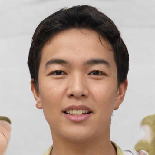 Joyful asian young-adult male with short  brown hair and brown eyes