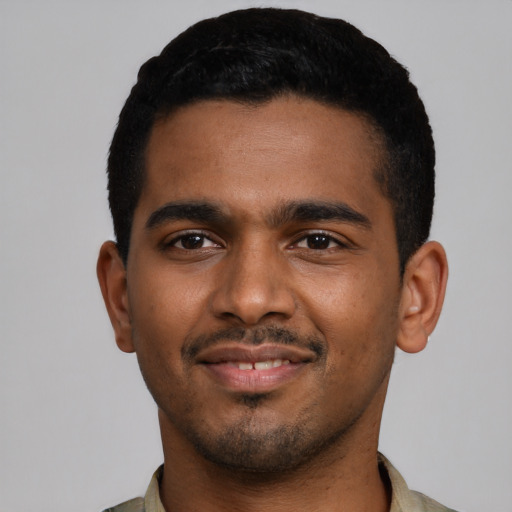 Joyful black young-adult male with short  black hair and brown eyes