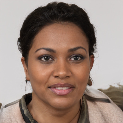 Joyful black young-adult female with medium  brown hair and brown eyes