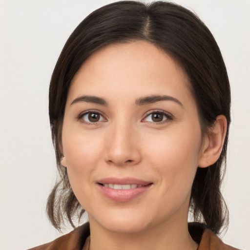 Joyful white young-adult female with medium  brown hair and brown eyes