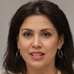 Joyful white adult female with long  brown hair and brown eyes