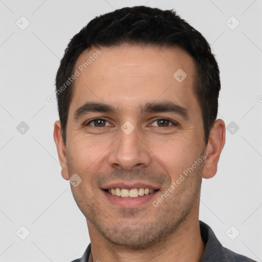 Joyful white young-adult male with short  black hair and brown eyes