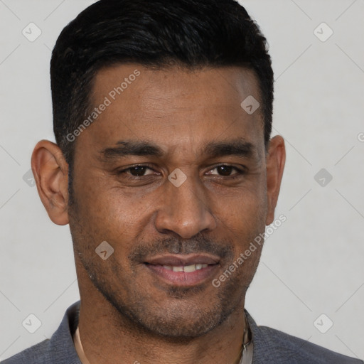 Joyful black adult male with short  black hair and brown eyes