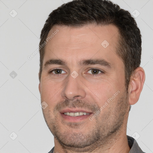 Joyful white young-adult male with short  brown hair and brown eyes