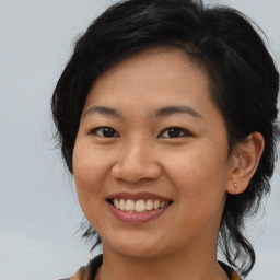 Joyful asian young-adult female with medium  black hair and brown eyes