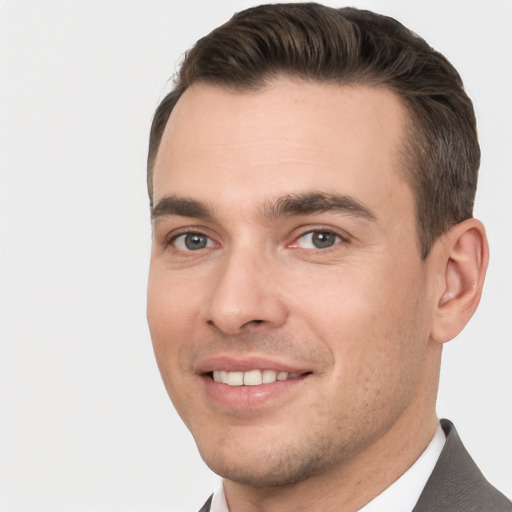 Joyful white young-adult male with short  brown hair and brown eyes