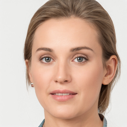 Joyful white young-adult female with medium  brown hair and blue eyes