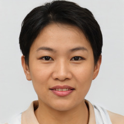 Joyful asian young-adult female with short  brown hair and brown eyes