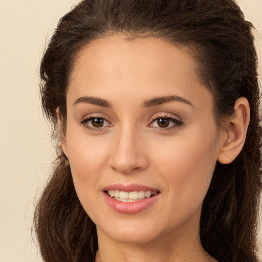 Joyful white young-adult female with long  brown hair and brown eyes