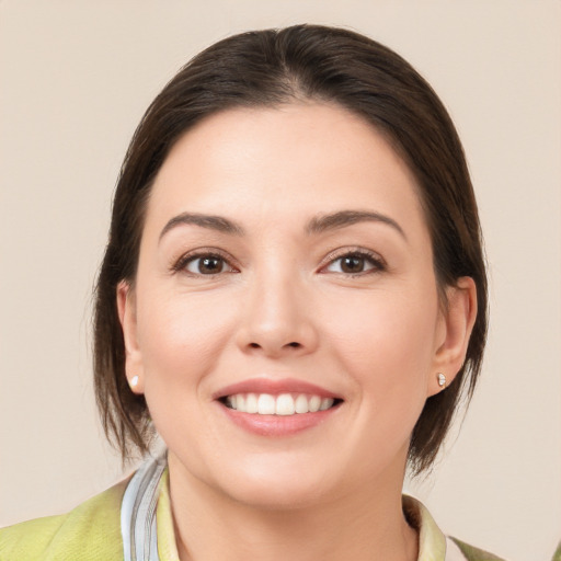 Joyful white young-adult female with medium  brown hair and brown eyes