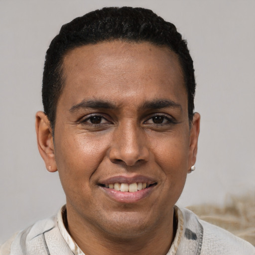 Joyful latino young-adult male with short  brown hair and brown eyes