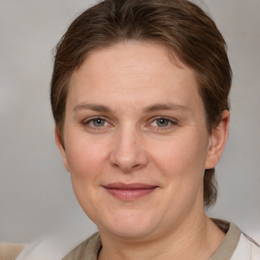 Joyful white adult female with short  brown hair and grey eyes