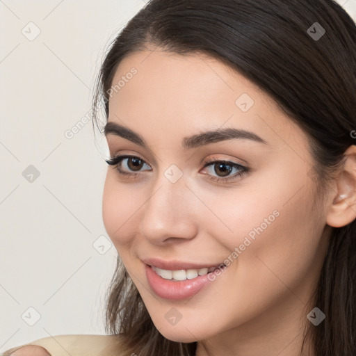 Joyful white young-adult female with long  brown hair and brown eyes