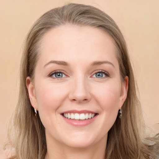 Joyful white young-adult female with long  brown hair and blue eyes