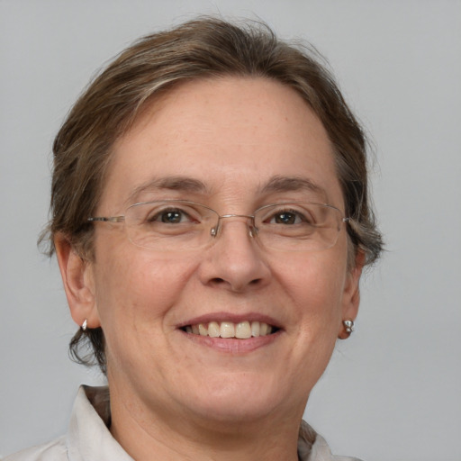 Joyful white adult female with medium  brown hair and grey eyes