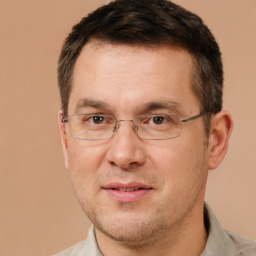 Joyful white adult male with short  brown hair and brown eyes