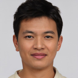 Joyful asian young-adult male with short  brown hair and brown eyes