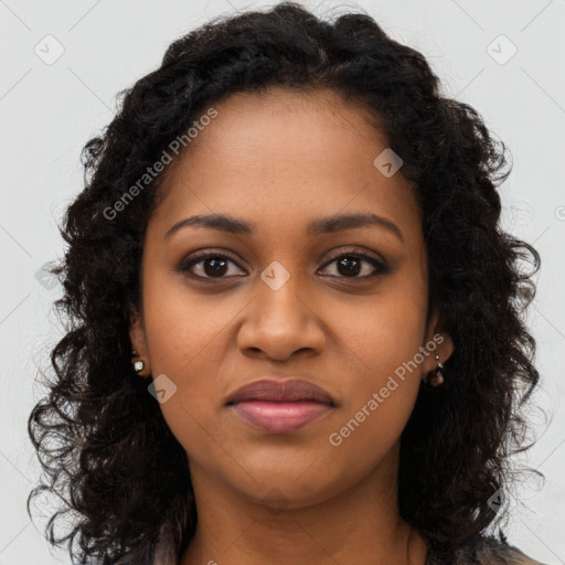 Joyful black young-adult female with long  brown hair and brown eyes