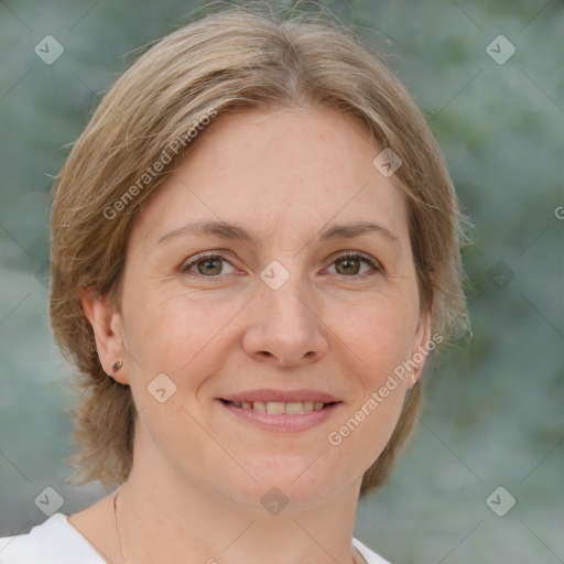 Joyful white adult female with medium  brown hair and green eyes