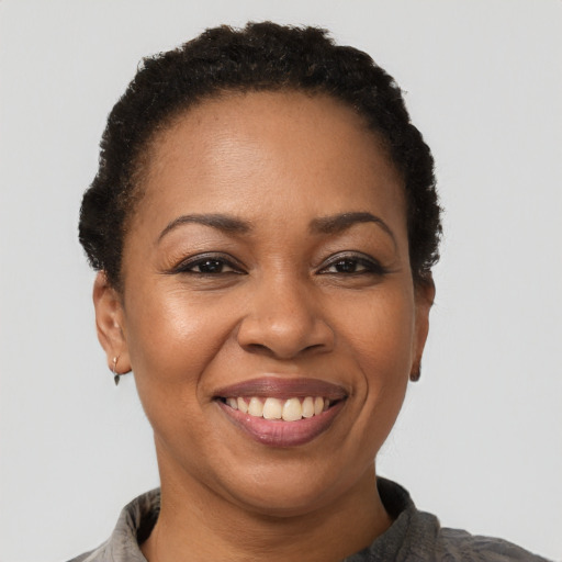 Joyful latino adult female with short  black hair and brown eyes