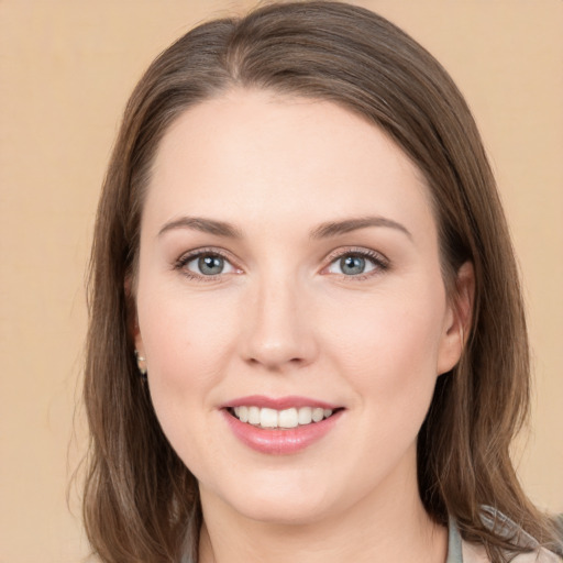 Joyful white young-adult female with medium  brown hair and grey eyes