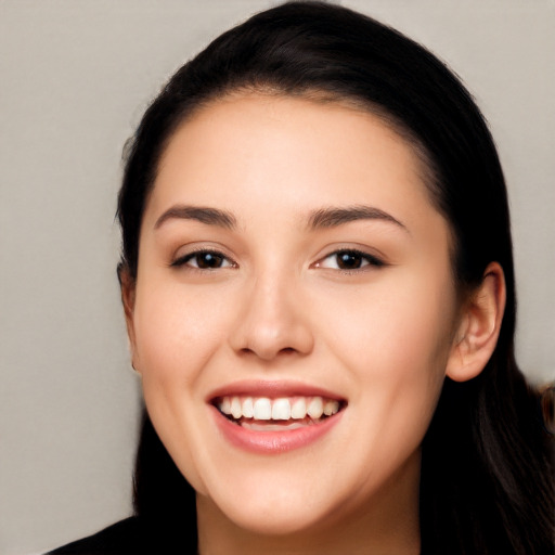 Joyful white young-adult female with long  black hair and brown eyes