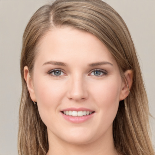 Joyful white young-adult female with long  brown hair and grey eyes