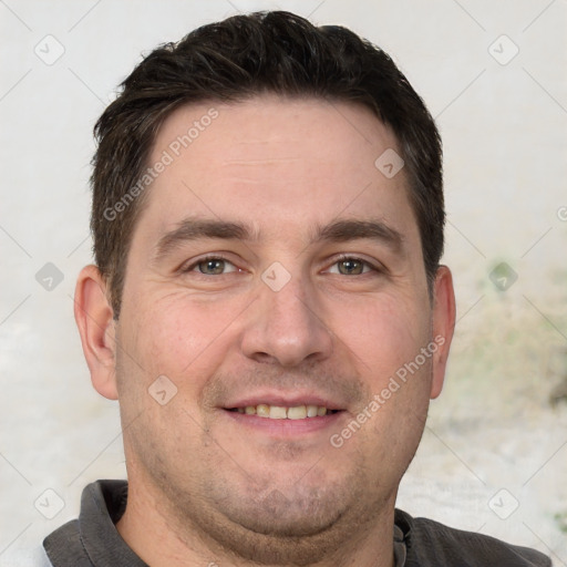 Joyful white adult male with short  brown hair and brown eyes