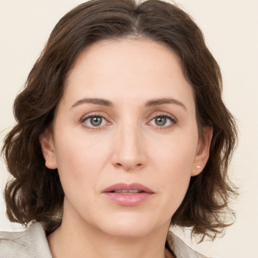 Joyful white young-adult female with medium  brown hair and green eyes