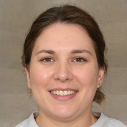 Joyful white adult female with medium  brown hair and brown eyes