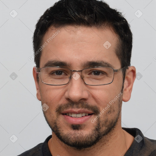 Joyful white adult male with short  black hair and brown eyes