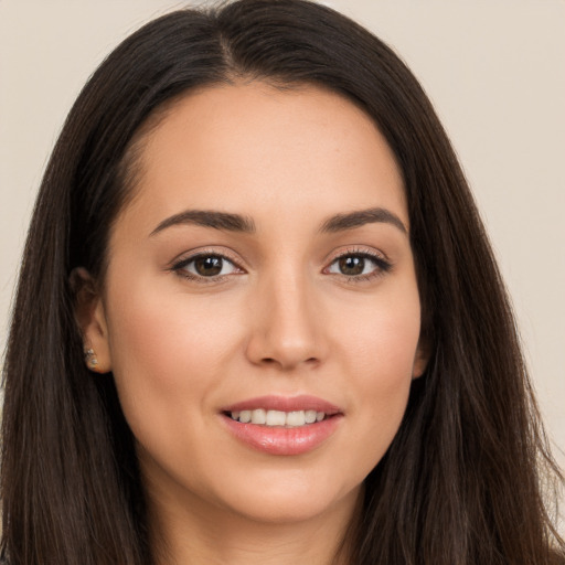 Joyful white young-adult female with long  brown hair and brown eyes