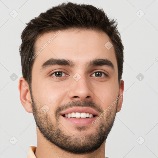 Joyful white young-adult male with short  brown hair and brown eyes