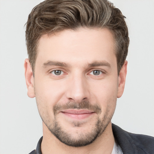 Joyful white young-adult male with short  brown hair and grey eyes