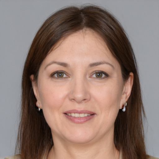 Joyful white adult female with medium  brown hair and grey eyes