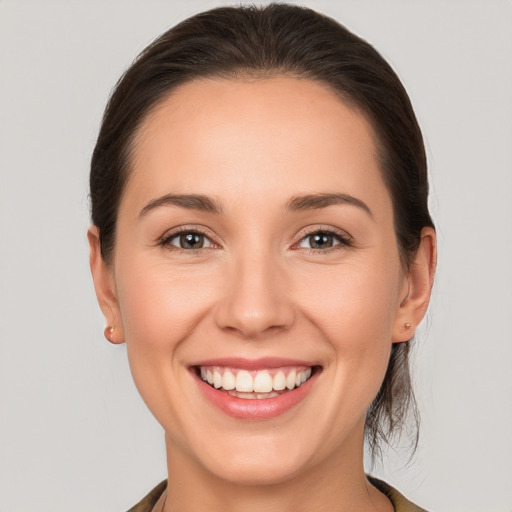 Joyful white young-adult female with medium  brown hair and brown eyes