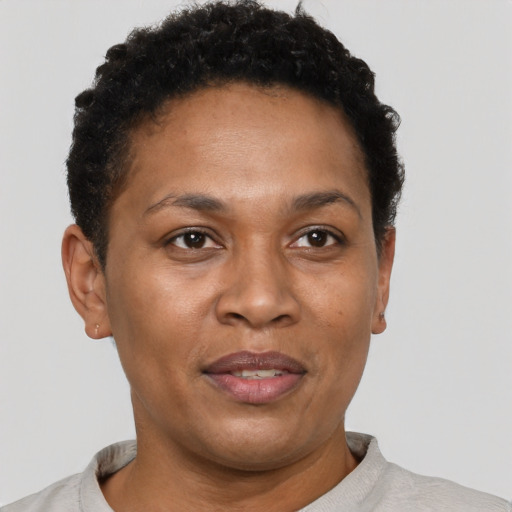Joyful black adult female with short  brown hair and brown eyes