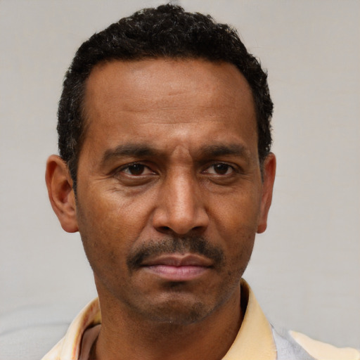 Neutral latino adult male with short  brown hair and brown eyes