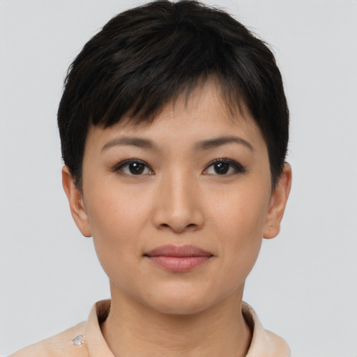 Joyful asian young-adult female with short  brown hair and brown eyes