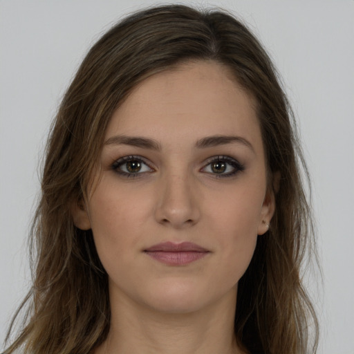 Joyful white young-adult female with long  brown hair and brown eyes