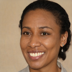 Joyful black adult female with short  brown hair and brown eyes