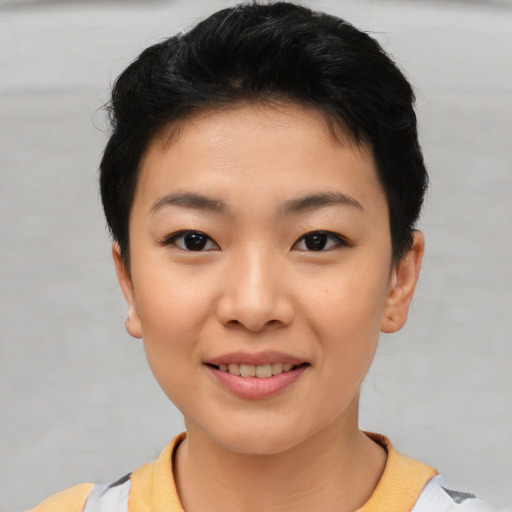 Joyful asian young-adult female with short  brown hair and brown eyes