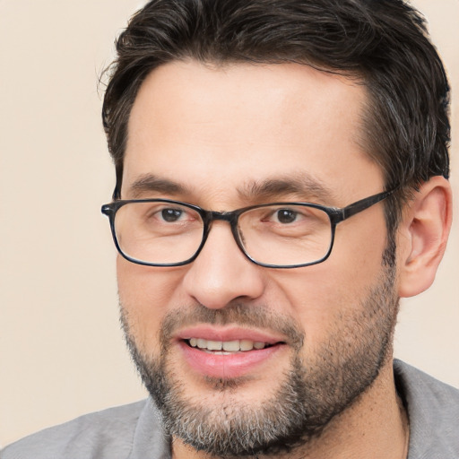 Joyful white adult male with short  brown hair and brown eyes