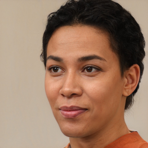 Joyful latino adult female with short  brown hair and brown eyes