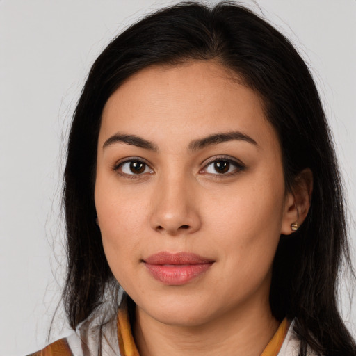 Joyful latino young-adult female with long  brown hair and brown eyes