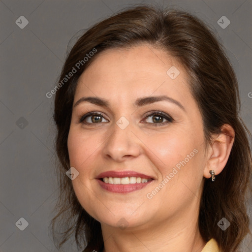 Joyful white adult female with medium  brown hair and brown eyes